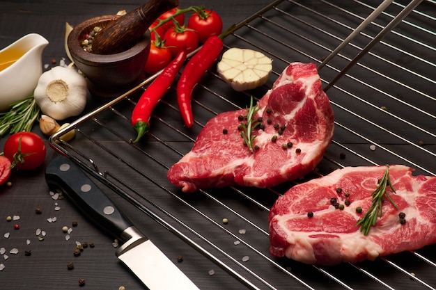 Filetes de ternera o cerdo crudos frescos en la parrilla de la parrilla