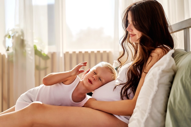 Filho pequeno e mãe grávida se abraçam