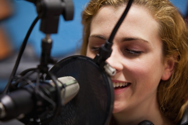 Foto fim de um jovem cantor gravando uma faixa