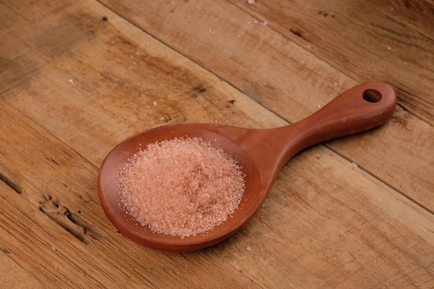 fina sal rosa del Himalaya en una cuchara de madera. minerales hierro, azufre, magnesio, calcio y potasio