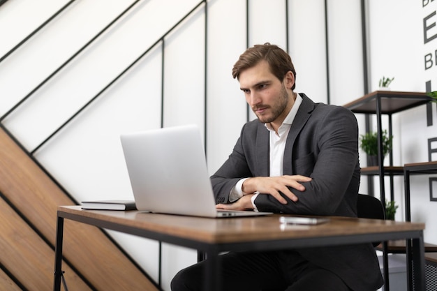 Finanzanalyst mit einem Laptop bei der Arbeit im Büro