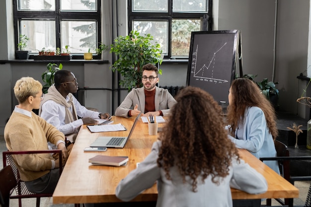 Finanzmanager sitzen am Tisch während der Besprechung der Arbeitspunkte