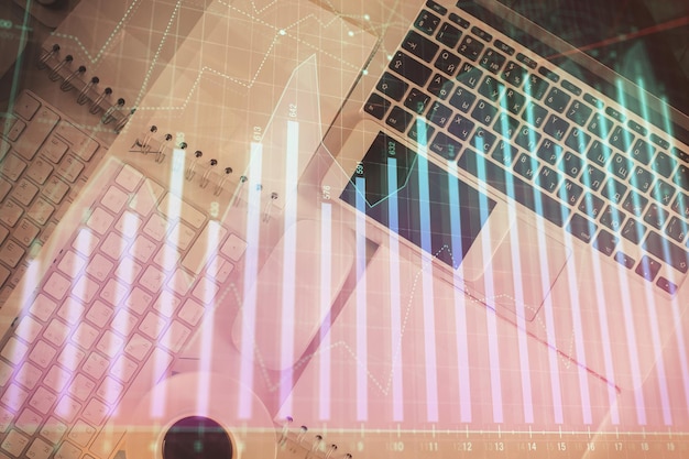 Finanzmarktdiagramm und Draufsichtcomputer auf dem Desktop-Hintergrund Multi-Exposure-Investitionskonzept