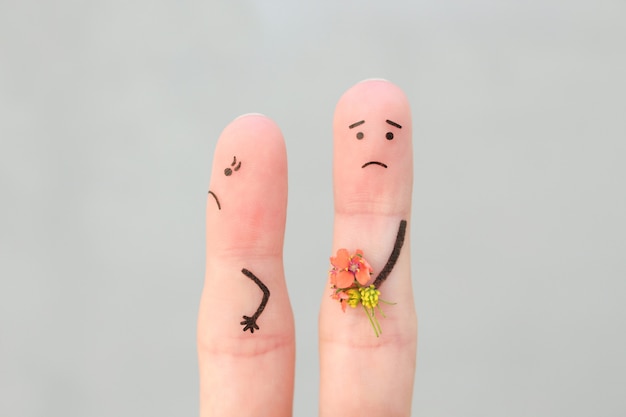 Fingerkunst des Paares. Mann schenkt einer Frau einen Blumenstrauß, sie ist nicht zufrieden.