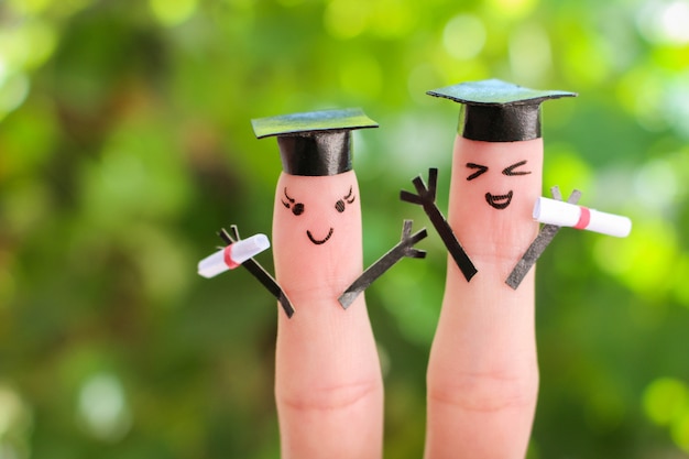 Fingerkunst von Freunden. Gruppe von Studenten, die ihr Diplom nach dem Abschluss halten