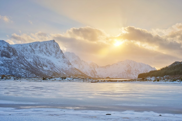 Fiordo noruego en invierno en puesta de sol