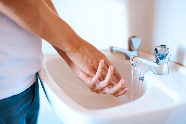 Fique a salvo de germes lavando as mãos regularmente captura de um homem irreconhecível lavando as mãos em uma bacia