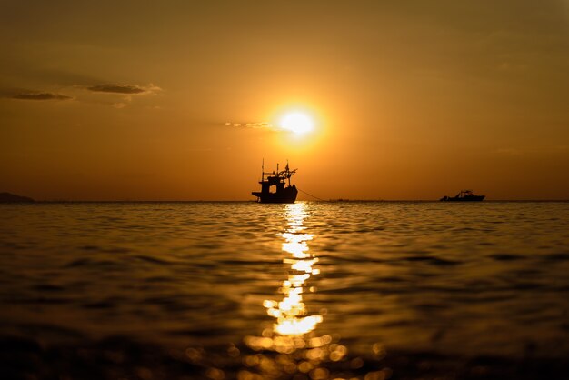 Fischermannboot mit Sonnenunterganghimmel