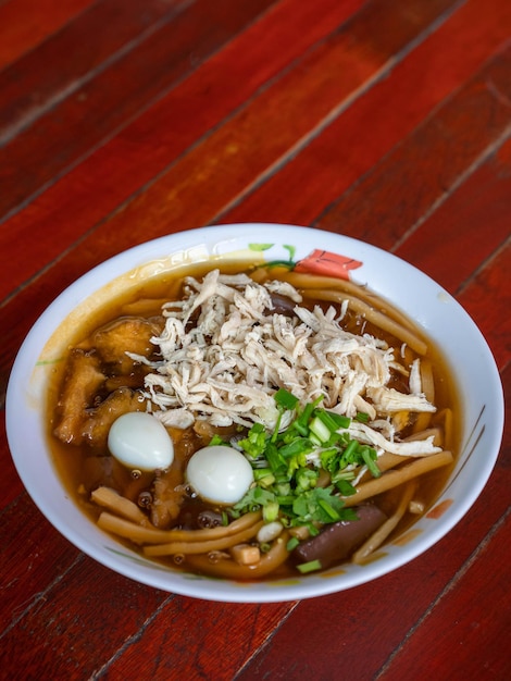 Fischschlundsuppe in einer weißen Tasse auf einem alten Tisch