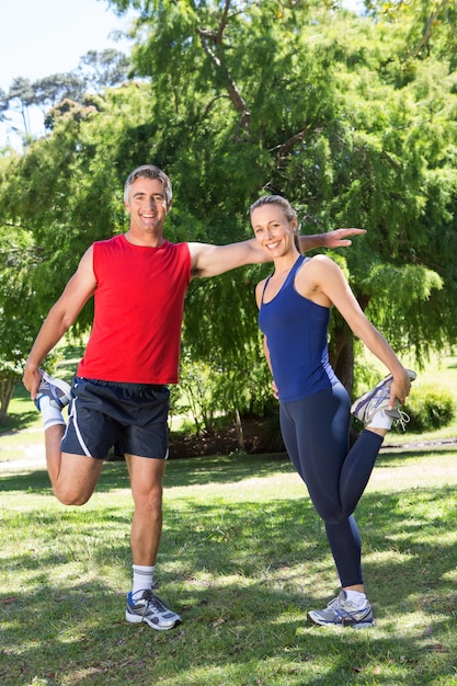 Fit couple stretching in the park