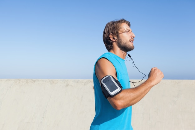 Fit man jogging on promenade