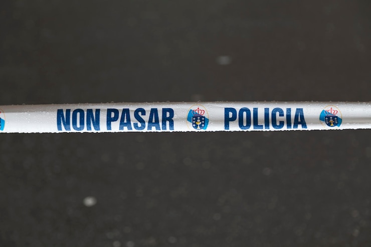 Foto fita policial com escrito nele em galego "non pasar - policia" que significa em inglês "não atravesse - polícia".