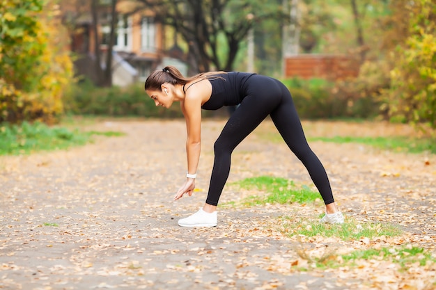 Foto fitness. frau, die streckübung auf park tut