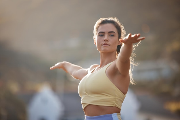 Fitness de yoga y ejercicio con una mujer entrenando al aire libre para el bienestar de la salud o un estilo de vida sereno Motivación de entrenamiento y zen con una joven atleta haciendo ejercicio al aire libre sola para mantenerse activa