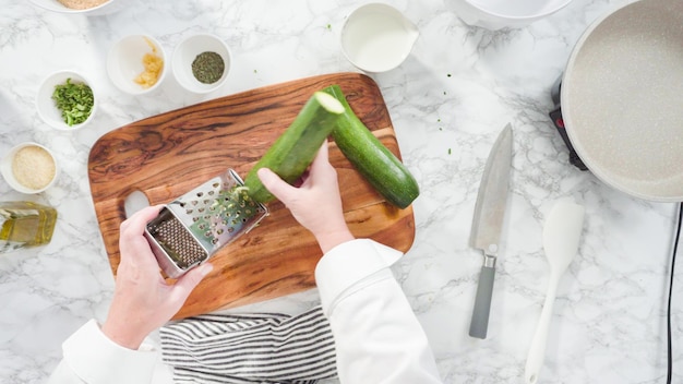 Flach liegen. Schritt für Schritt. Bio-Zucchini zerkleinern, um Zucchinikuchen herzustellen.