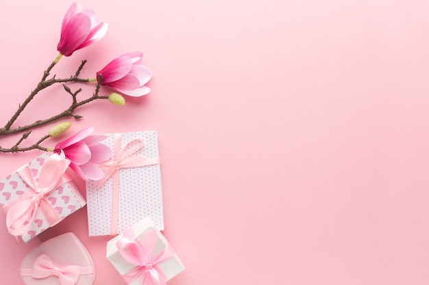 Flache Lage der rosa Geschenke mit Magnolie und Kopienraum