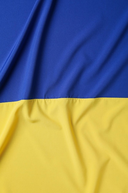 Flagge der Ukraine auf dem gesamten Hintergrundkonzept nationaler Symbole