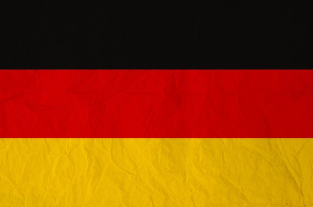 Foto flagge des deutschlands mit altem papier der weinlese