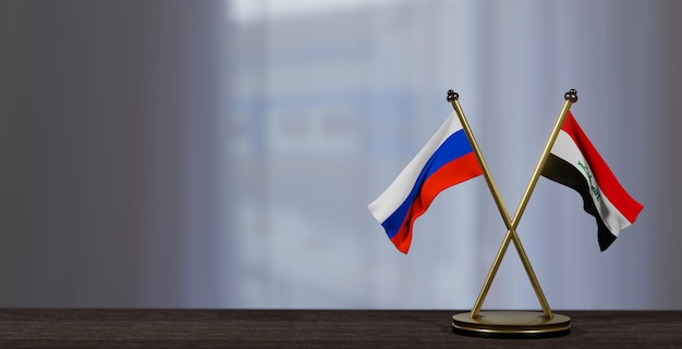 Flaggen Russlands und des Irak auf dem Tisch Verhandlungen zwischen dem Irak und Russland auf wenig unscharfem Hintergrund 3D-Arbeit und 3D-Bild