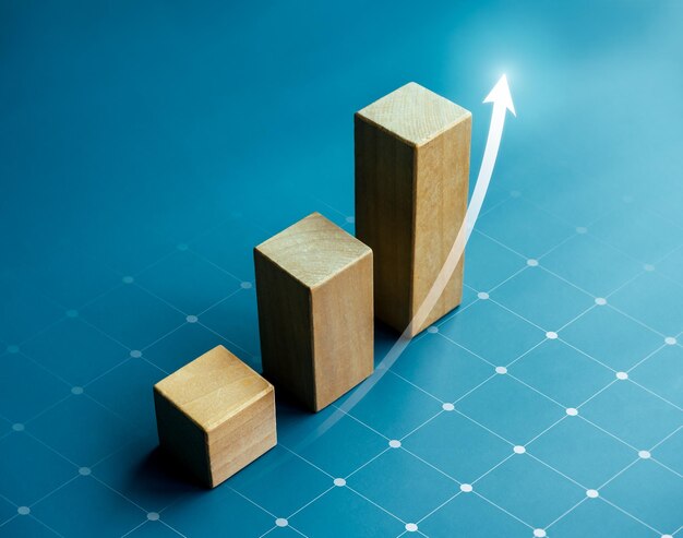 Flecha ascendente brillante en bloques de cubo de madera tabla de pasos de gráfico de barras sobre fondo azul beneficio beneficio ingresos crecimiento empresarial tecnología tendencia mejora económica conceptos vista superior