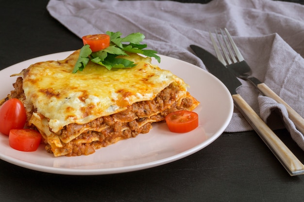 Fleischlasagne auf einem Holztisch.