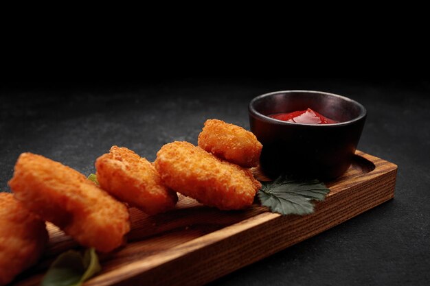 Fleischnuggets mit Ketchup auf dunklem Hintergrund