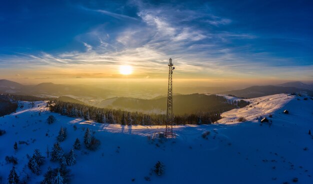 Fliegen über Funkturm in Bergen, schneebedeckte Winterlandschaft.