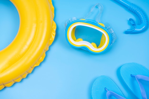 Flip-flop e máscara de mergulho com anel colorido flutuante amarelo