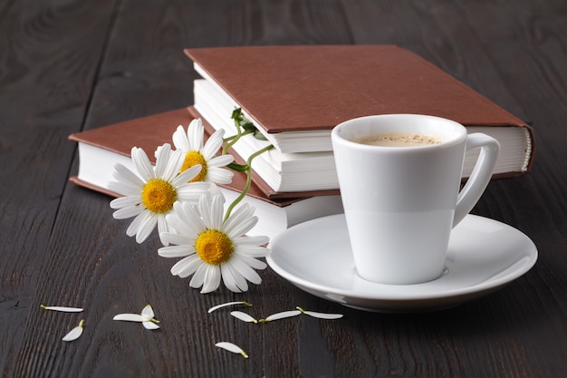 Flor livro e margarida na mesa de madeira