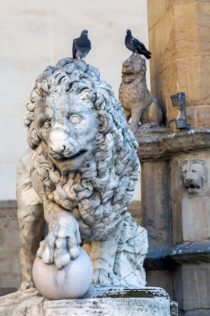 Florenz-Löwenstatue mit einem Vogel auf dem Kopf, hergestellt von Vacca 1598 in der Loggia dei Lanzi, Italien