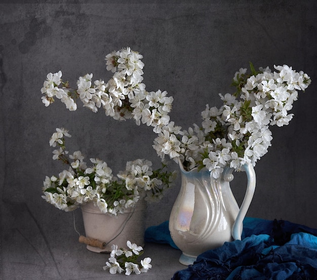 Flores de cerejeira em vaso branco em cinza