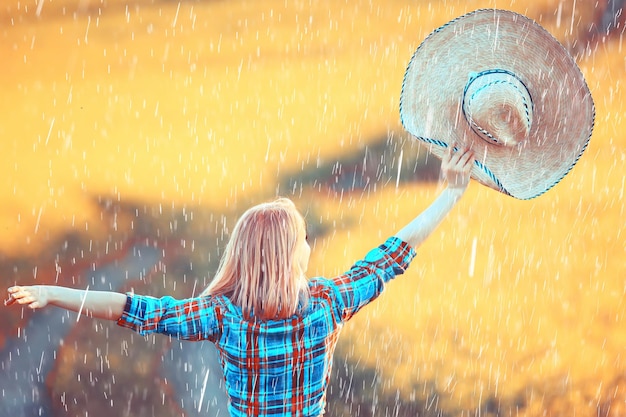 Flores de menina de campo de chuva de verão, bela jovem no campo de primavera com flores felicidade liberdade