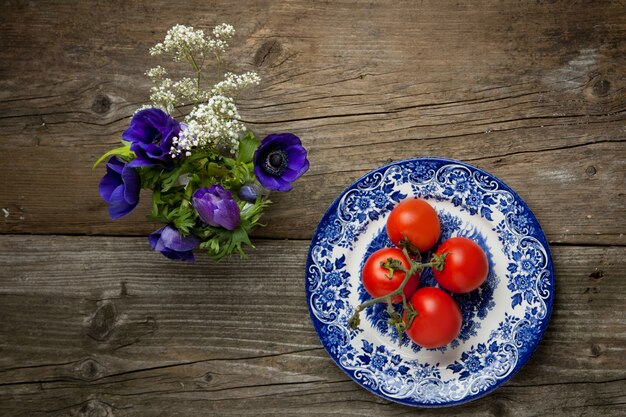 Flores e prato com tomates frescos