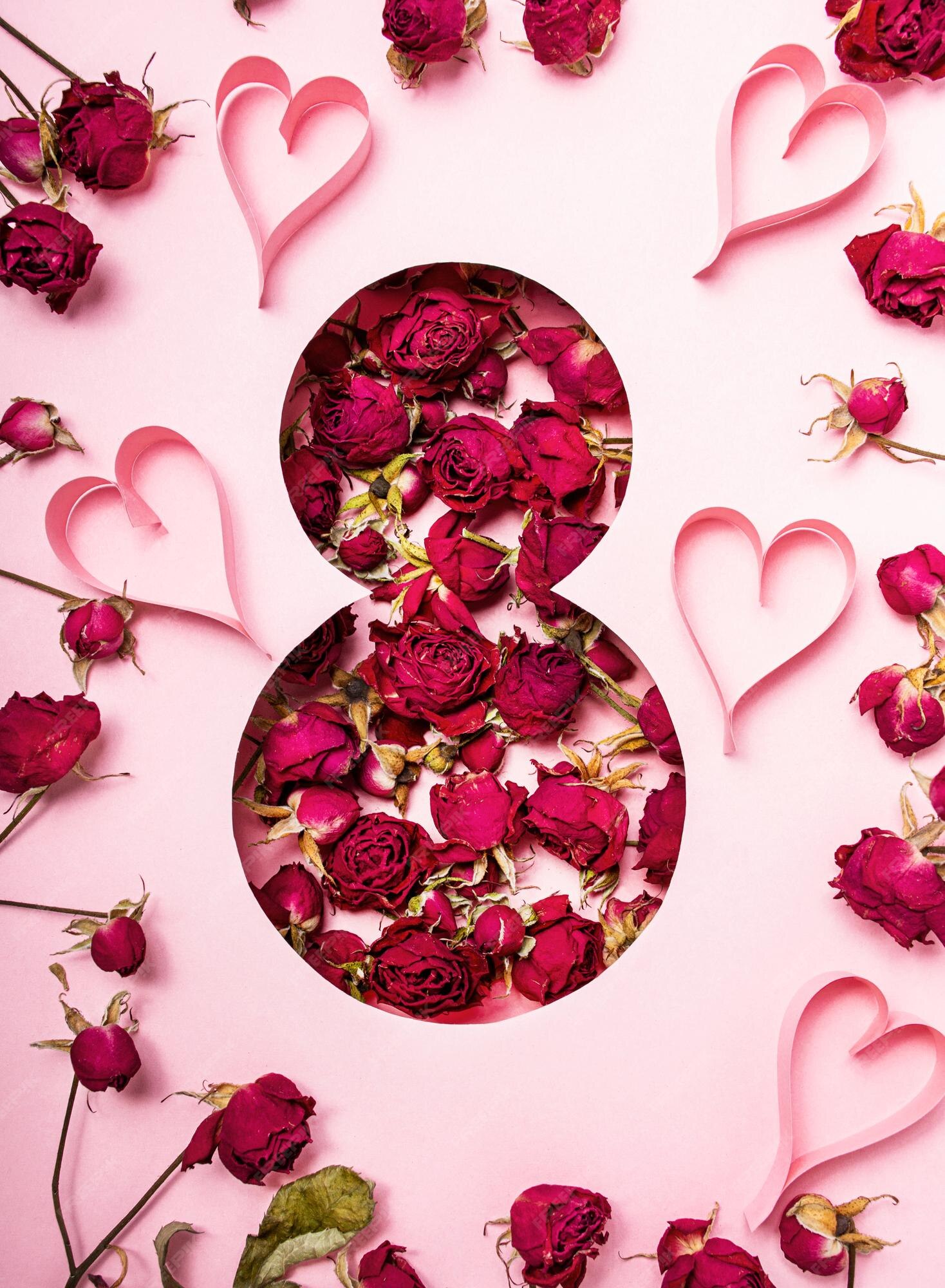 Flores en forma de ocho con corazones sobre fondo rosa día internacional de  la mujer | Foto Premium