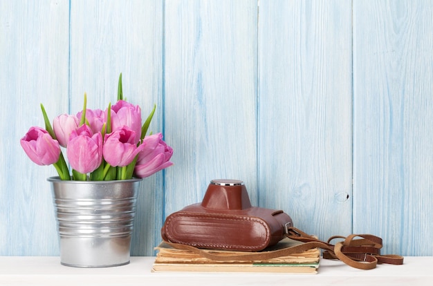 Flores frescas de tulipa rosa e câmera