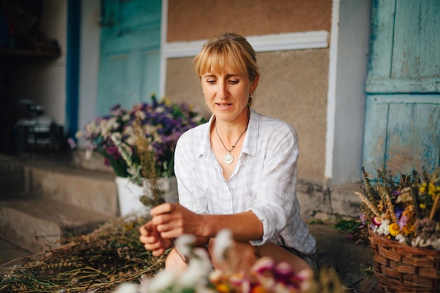 Florista faz uma composição de flores secas