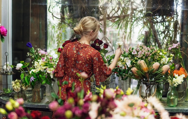 Foto florista organizando lisianthus em sua loja