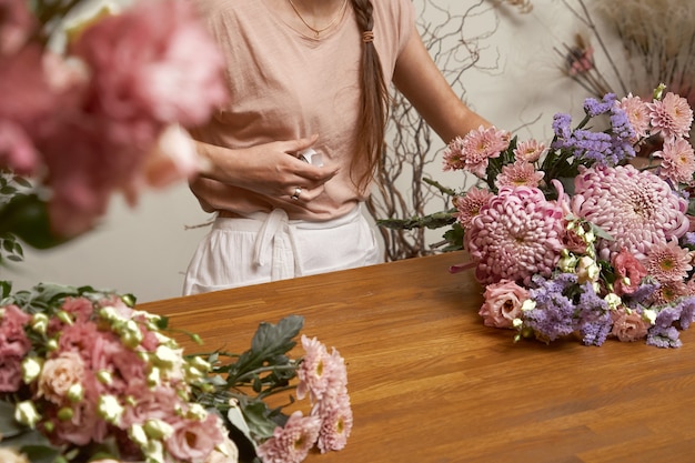 Floristería joven en su estudio haciendo un hermoso ramo