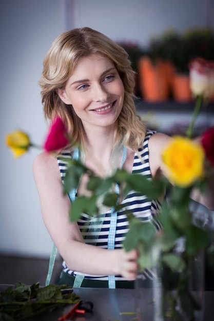 Floristería mujer arreglando flores