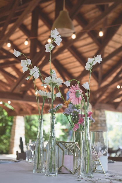 Foto florística decoração floral do casamento em tons pastéis muitas flores em vasos e vasilhas diferentes