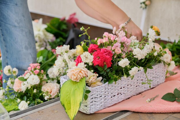 Floristin, die mit Blumen im Freien arbeitet und Veranstaltungen mit Blumen dekoriert