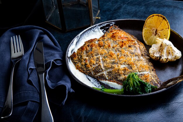 Flunderfilet in einer Pfanne mit Kräutern und Zitrone gebraten