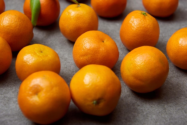 Foco seletivo de tangerinas orgânicas na mesa cinza