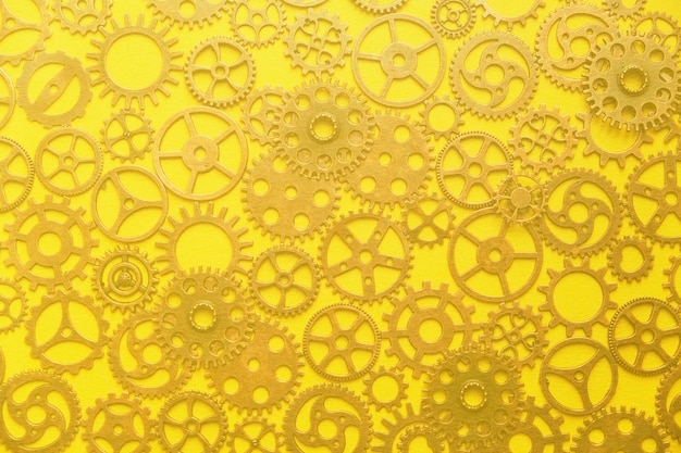 Fondo, una abstracción de un engranaje sobre un fondo amarillo.