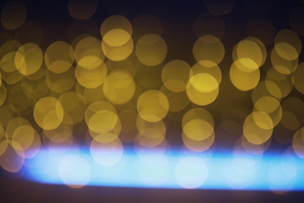 Fondo abstracto bokeh Círculos dorados bokeh sobre un fondo azul oscuro Superposición de capa
