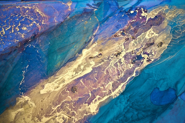 Fondo abstracto de lujo en técnica de tinta de alcohol, pintura líquida de oro azul índigo, manchas acrílicas dispersas y manchas arremolinadas, materiales impresos