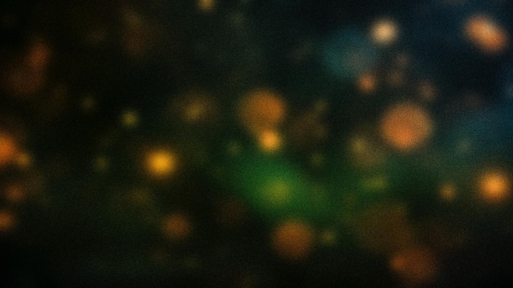 Foto fondo abstracto místico en tonos verde naranja y azul oscuro con una textura granulada y luces bokeh suaves ideales para papeles de pared de mal humor y arte digital creativo