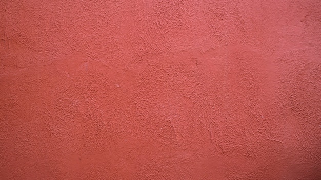 Fondo abstracto de muro de hormigón de estuco rojo con luz solar, luz y sombra