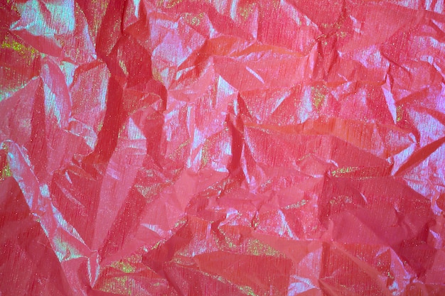 Fondo abstracto de papel arrugado holográfico rosa púrpura arrugado