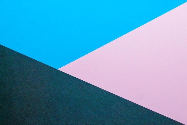 Fondo abstracto con papel de color azul con color rosa.